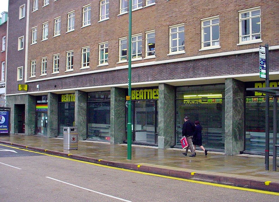 Beatties Nottingham. Marble on the ground floor with brown brick on the others with bright yellow Beatties logos