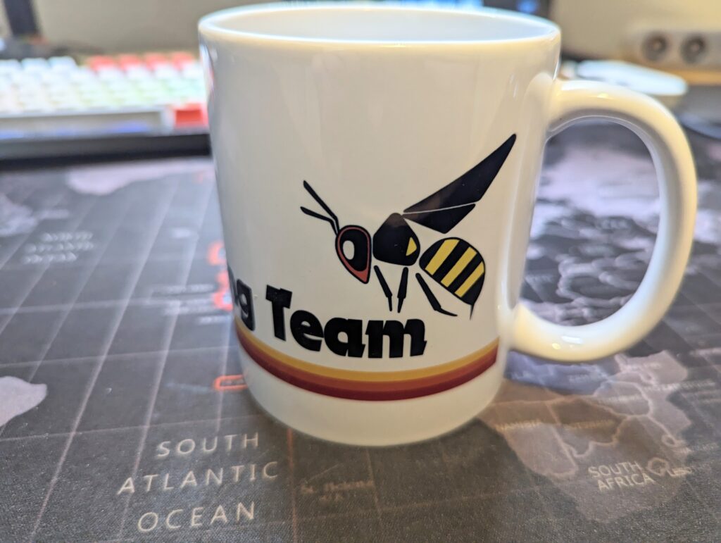 Hornet Racing Team Mug. With a text and Hornet logo and stripe on a white mug